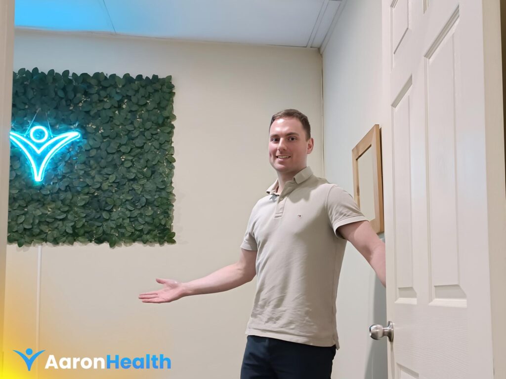Dr. Nathan Cogoi welcoming patients at Aaron Health Chiropractic Care